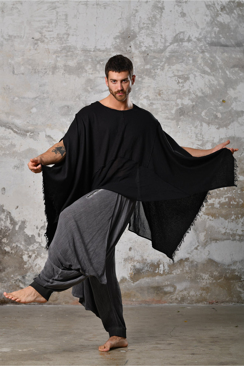 An enchanting Bohemian black poncho blouse unisex, perfect for boho and festival-inspired looks, exuding a goddess-like quality. black bohemian style perfect for Burning Man and other occasions. Menswear Boho Shirt. Boho sleeveless poncho unisex yogi