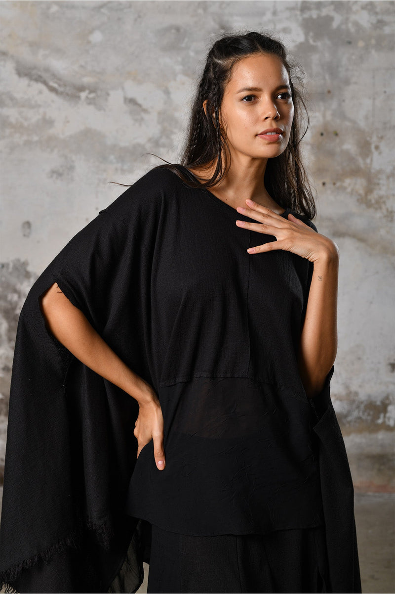 An enchanting Bohemian black poncho blouse unisex, perfect for boho and festival-inspired looks, exuding a goddess-like quality. black bohemian style perfect for Burning Man and other occasions. Menswear Boho Shirt. Boho sleeveless poncho unisex yogi