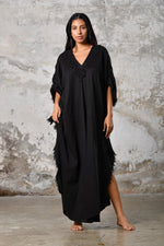 A versatile,black earthy goddess dress that embodies boho-chic style. Crafted from the softest cotton fabric, this garment offers both comfort and a fashion statement. The dress can be worn in two distinct styles, either as a kaftan or a sultry dress, with a simple change in the way you put it on. Its natural and ethereal design exudes a warm, comforting feeling against your skin, making it a must-have addition to your wardrobe for those seeking a harmonious blend of style and comfort.