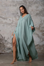 A versatile, earthy goddess dress that embodies boho-chic style. Crafted from the softest cotton fabric, this garment offers both comfort and a fashion statement. The dress can be worn in two distinct styles, either as a kaftan or a sultry dress, with a simple change in the way you put it on. Its natural and ethereal design exudes a warm, comforting feeling against your skin, making it a must-have addition to your wardrobe for those seeking a harmonious blend of style and comfort.