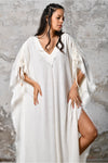 A versatile, White earthy goddess dress that embodies boho-chic style. Crafted from the softest cotton fabric, this garment offers both comfort and a fashion statement. The dress can be worn in two distinct styles, either as a kaftan or a sultry dress, with a simple change in the way you put it on. Its natural and ethereal design exudes a warm, comforting feeling against your skin, making it a must-have addition to your wardrobe for those seeking a harmonious blend of style and comfort.