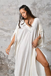 A versatile, White earthy goddess dress that embodies boho-chic style. Crafted from the softest cotton fabric, this garment offers both comfort and a fashion statement. The dress can be worn in two distinct styles, either as a kaftan or a sultry dress, with a simple change in the way you put it on. Its natural and ethereal design exudes a warm, comforting feeling against your skin, making it a must-have addition to your wardrobe for those seeking a harmonious blend of style and comfort.