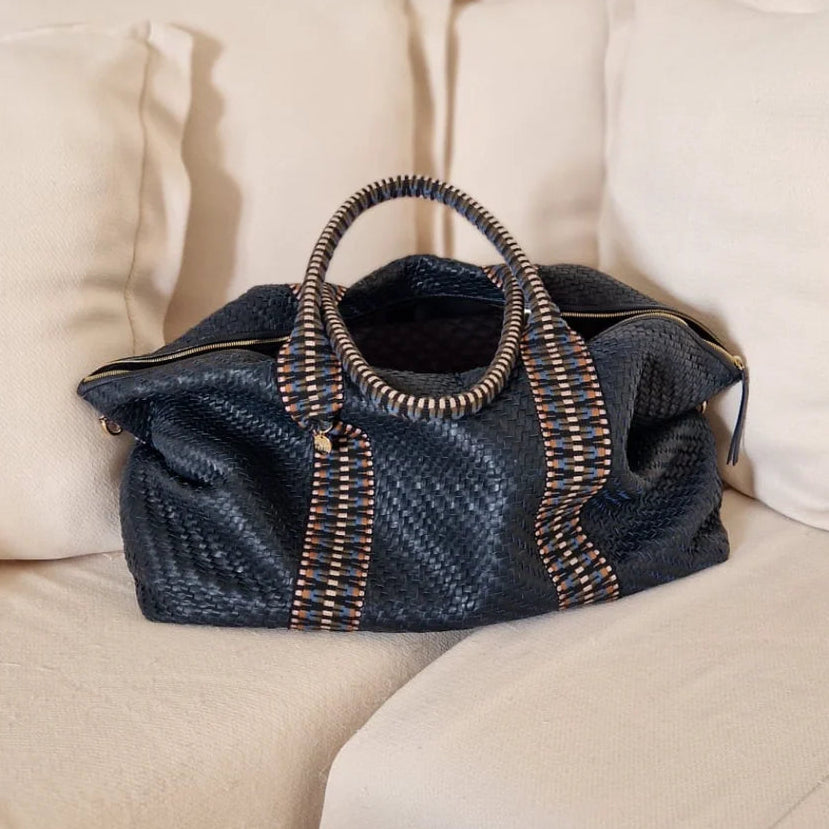 Black textured handbag with a strap on a white background